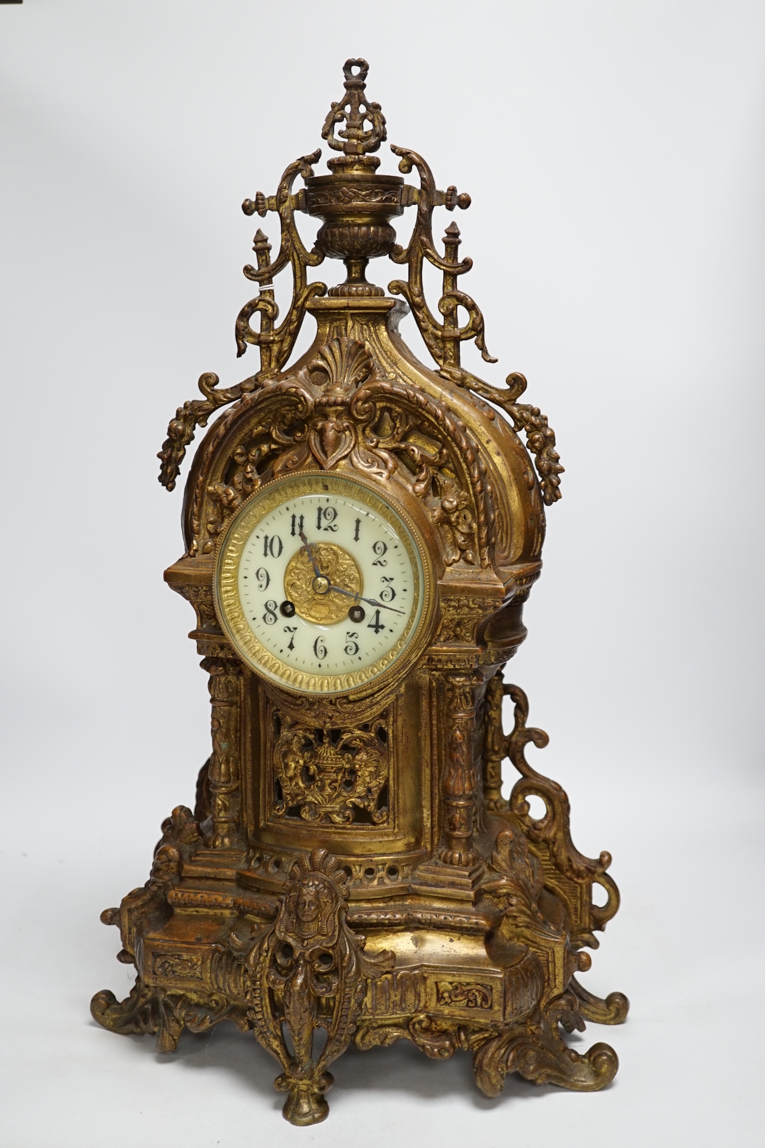 An ornately cast French bronze mantel clock, 57cm high